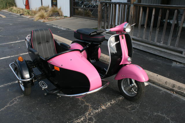 pink vespa with sidecar